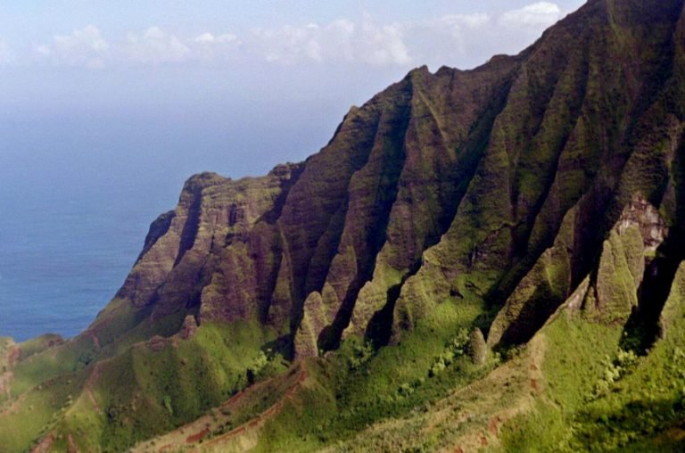 What to Pack for the Kalalau Trail (Complete Nā Pali Coast Gear List) Steep fluted cliff terrain above Kalalau Valley, Na Pali Coast, Kauai